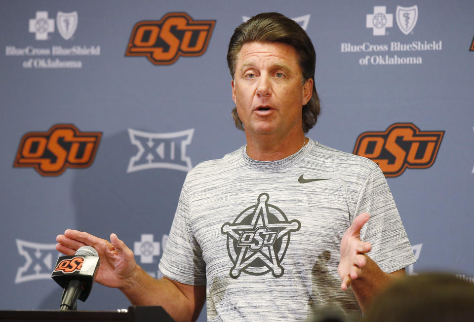 Oklahoma State head coach Mike Gundy gestures as he answers a question during an NCAA college football media day in Stillwater, Okla., Saturday, Aug. 4, 2018. (AP Photo/Sue Ogrocki)