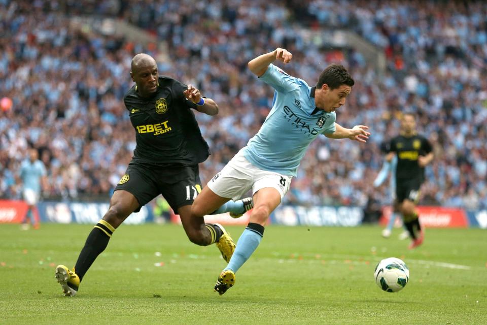 Manchester City's Samir Nasri and Wigan Athletic's Emmerson Boyce (left) battle for the ball