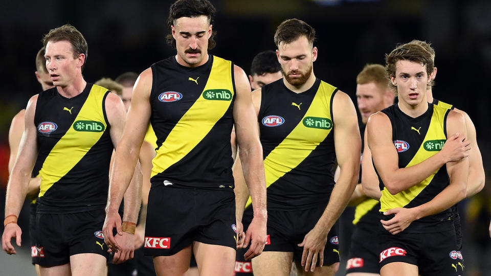 Richmond Tigers players walk off the ground.