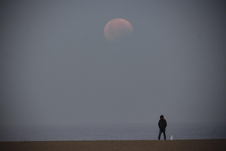 A man walks along Santa Monica Beach on May 26, 2021 in Santa Monica, California during the 