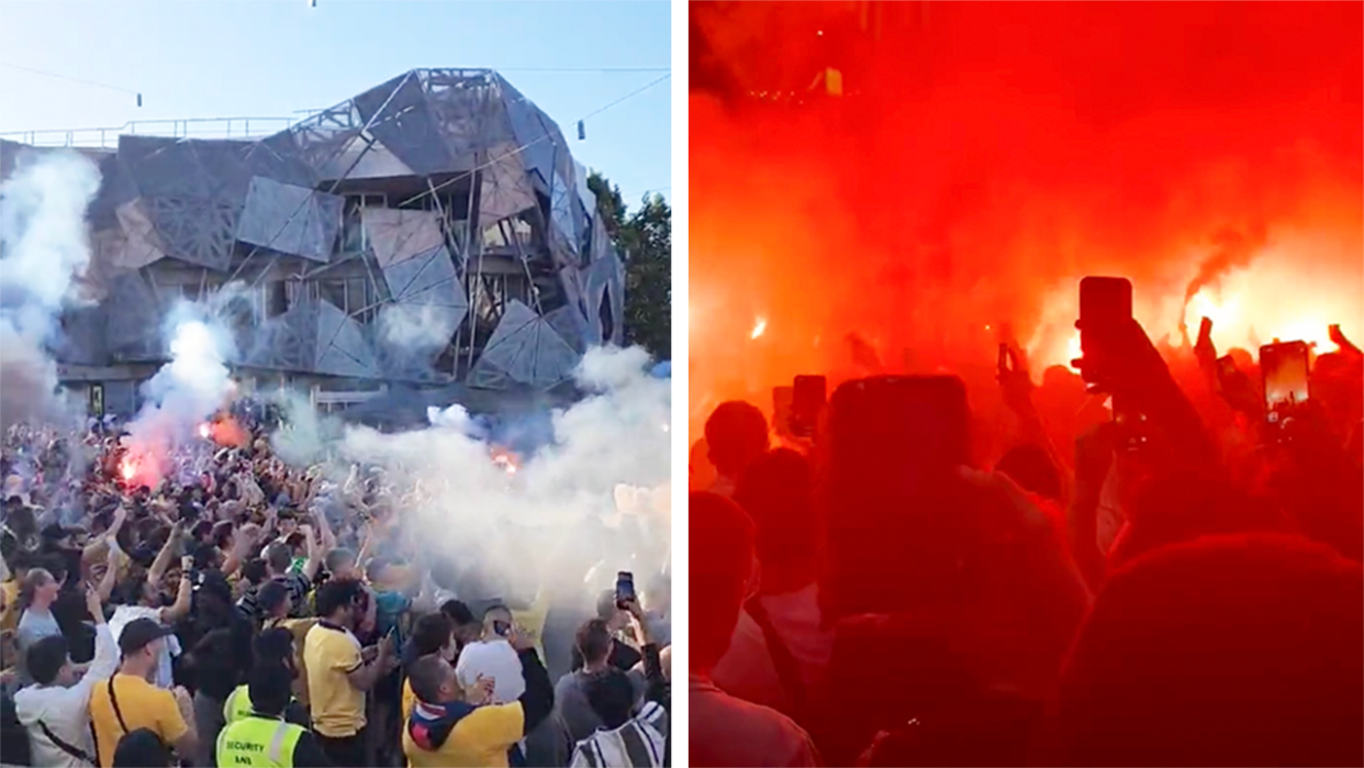 Fans let off flares at Fed Square during the Socceroos match.