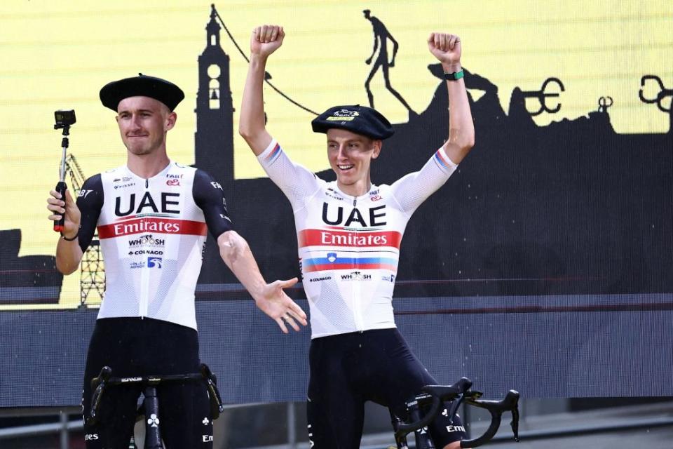 UAE Team Emirates Danish rider Mikkel Bjerg L points to UAE Team Emirates Slovenian rider Tadej Pogacar R as they take to the stage during the official teams presentation near the Guggenheim Museum Bilbao in Bilbao northern Spain on June 29 2023 two days prior to the start of the 110th edition of the Tour de France cycling race Photo by AnneChristine POUJOULAT  AFP Photo by ANNECHRISTINE POUJOULATAFP via Getty Images