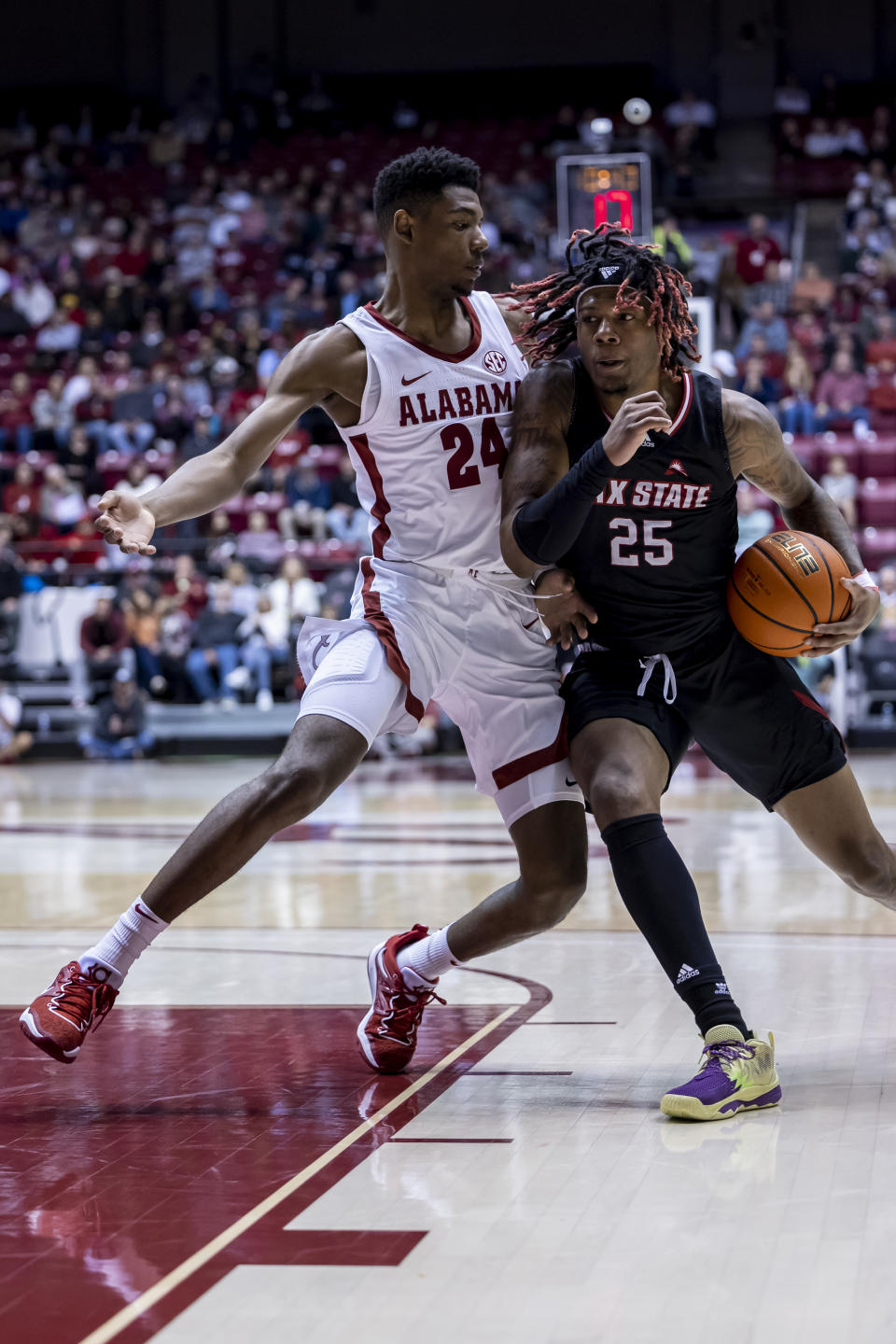 Jacksonville State forward Clarence Jackson (25) tries to get past Alabama forward Brandon Miller (24) during the first half of an NCAA college basketball game, Friday, Nov. 18, 2022, in Tuscaloosa, Ala. (AP Photo/Vasha Hunt)