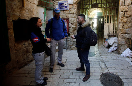 A man speaks with members of the Temporary International Presence in Hebron (TIPH) near an Israeli checkpoint in Hebron, in the Israeli-occupied West Bank January 29, 2019. REUTERS/Mussa Qawasma