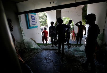 People survey the damage in a government office following violence in Panchkula, India, August 26, 2017. REUTERS/Cathal McNaughton