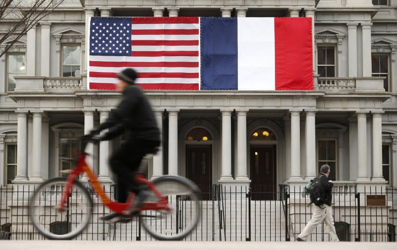 U.S. and French flags fly next to the White House to honor French President Hollande in Washington