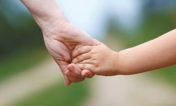 A women holding a child's hand/courtesy photo