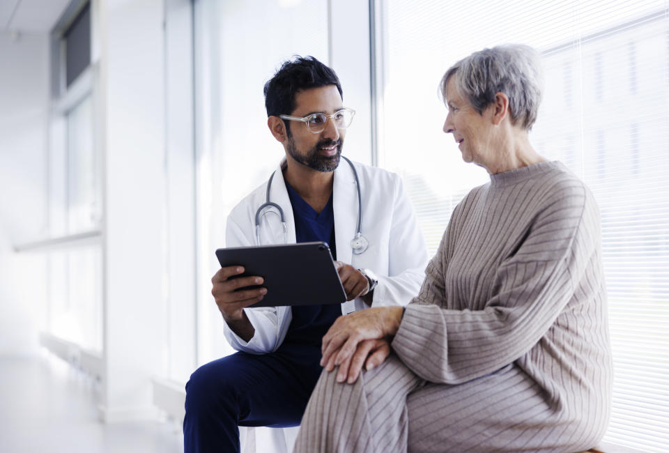 a doctor talking to an elderly woman