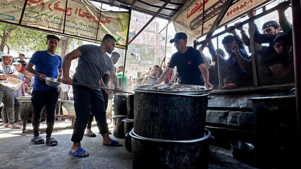 People in southern Gaza queue to receive a bowl of food for their families from charity organizations, on May 3, 2024. - Doaa Albaz/Anadolu/Getty Images