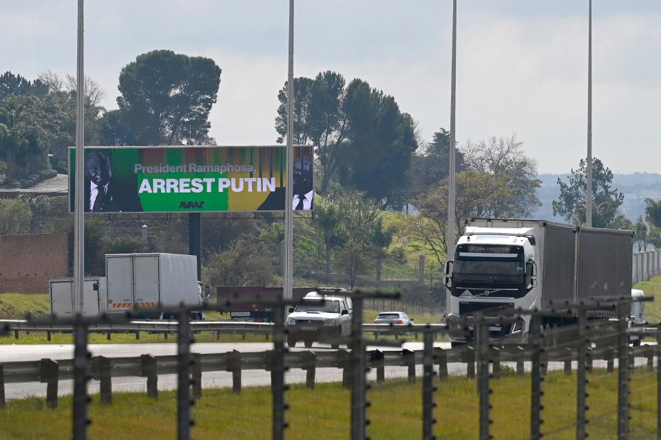 A billboard from a campaign by the Avaaz organization, urging South African President Cyril Ramaphosa to arrest Russian President Vladimir Putin if he attends a planned summit in the country in August, is seen near Centurion, South Africa,   May 31, 2023. / Credit: LUCA SOLA/AFP/Getty