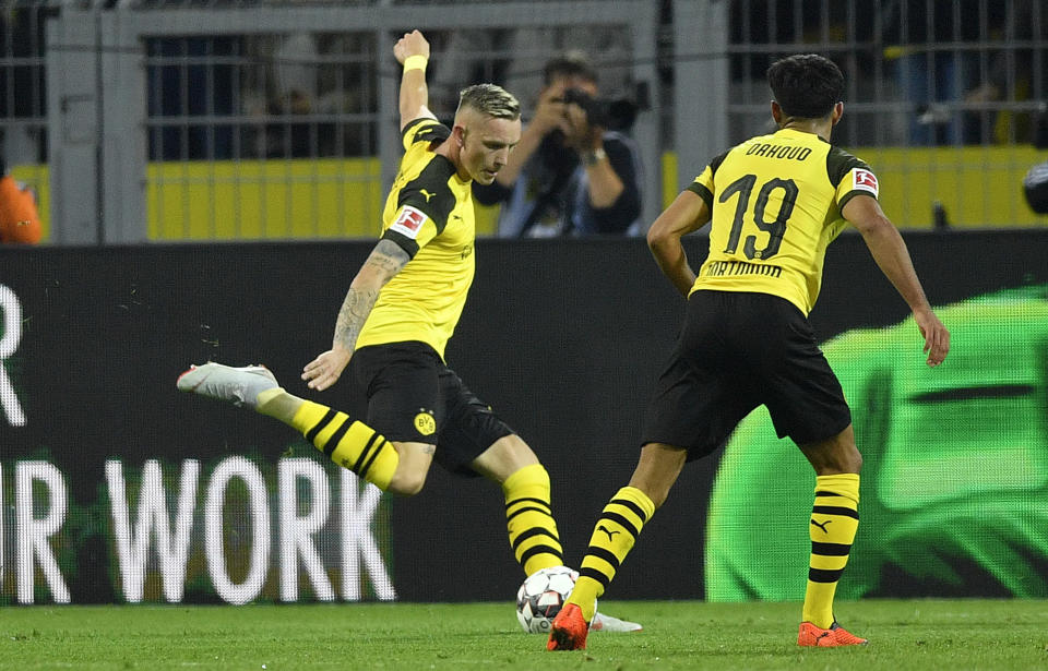 Dortmund's Marius Wolf scores his side's second goal during the German Bundesliga soccer match between Borussia Dortmund and Eintracht Frankfurt in Dortmund, Germany, Friday, Sept. 14, 2018. (AP Photo/Martin Meissner)