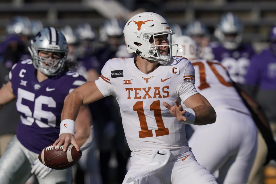 Texas quarterback Sam Ehlinger (11) passes to a teammate during the first half of an NCAA college football game against Kansas State in Manhattan, Kan., Saturday, Dec. 5, 2020. (AP Photo/Orlin Wagner)