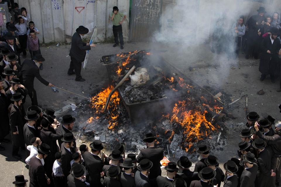 Ultra-Orthodox Jewish men burn leavened items in final preparation for the Passover holiday in the ultra-Orthodox Jewish town of Bnei Brak, near Tel Aviv, Israel, Monday, April 14, 2014. Jews are forbidden to eat leavened foodstuffs during the Passover holiday that celebrates the biblical story of the Israelites' escape from slavery and exodus from Egypt. (AP Photo/Oded Balilty)