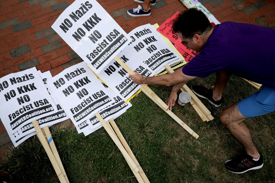 <p>Demonstrators select anti-KKK signs ahead of the planned white supremacist Unite the Right rally in Lafayette Park rally across from the White House August 12, 2018 in Washington, DC. Thousands of protesters are expected to demonstrate against the “white civil rights” rally, which was planned by the organizer of last yearÕs deadly rally in Charlottesville, Virginia. (Photo: Chip Somodevilla/Getty Images) </p>