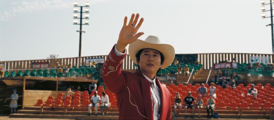 Jupe raising his hand, you can see embroidery on his suit sleeve