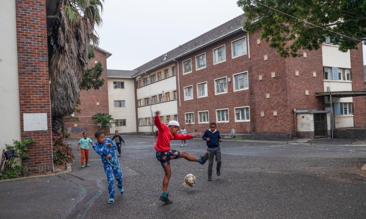 <span>Children play after school outside of the occupied Cissie Gool House in Woodstock, Cape Town.</span><span>Photograph: Julie Bourdin</span>