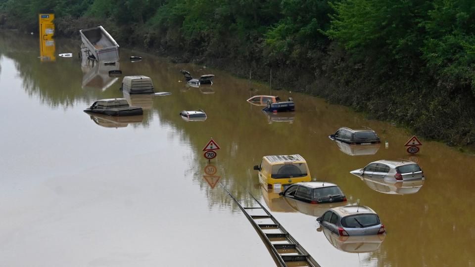 Submerged cars and other vehicles are seen on the federal highway B265 in Erftstadt, western Germany, on July 17, 2021 after heavy rains hit parts of the country, causing widespread flooding and major damage. - Rescue workers scrambled on July 17 to find survivors and victims of the devastation wreaked by the worst floods to hit western Europe in living memory, which have already left more than 150 people dead and dozens more missing. (Photo by SEBASTIEN BOZON / AFP)