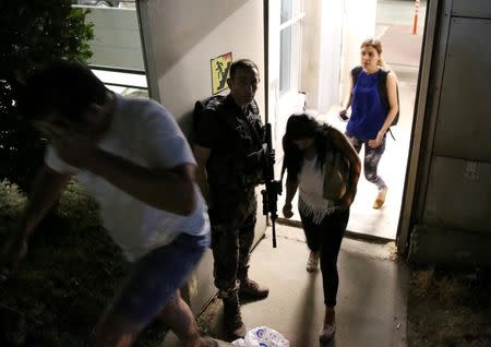 Armed security man escorts people from a carpark at Istanbul Ataturk airport, Turkey, following a blast June 28, 2016. REUTERS/Goran Tomasevic