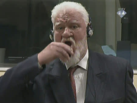 A wartime commander of Bosnian Croat forces, Slobodan Praljak, is seen during a hearing at the U.N. war crimes tribunal in the Hague, Netherlands, November 29, 2017. ICTV via REUTERS TV