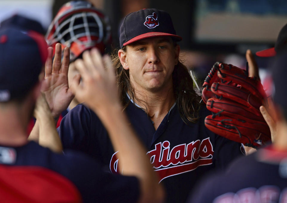 Cleveland Indians starting pitcher Mike Clevinger is congratulated int he dugout in the fifth inning of a baseball game against the Detroit Tigers, Saturday, Sept.15, 2018, in Cleveland. (AP Photo/David Dermer)