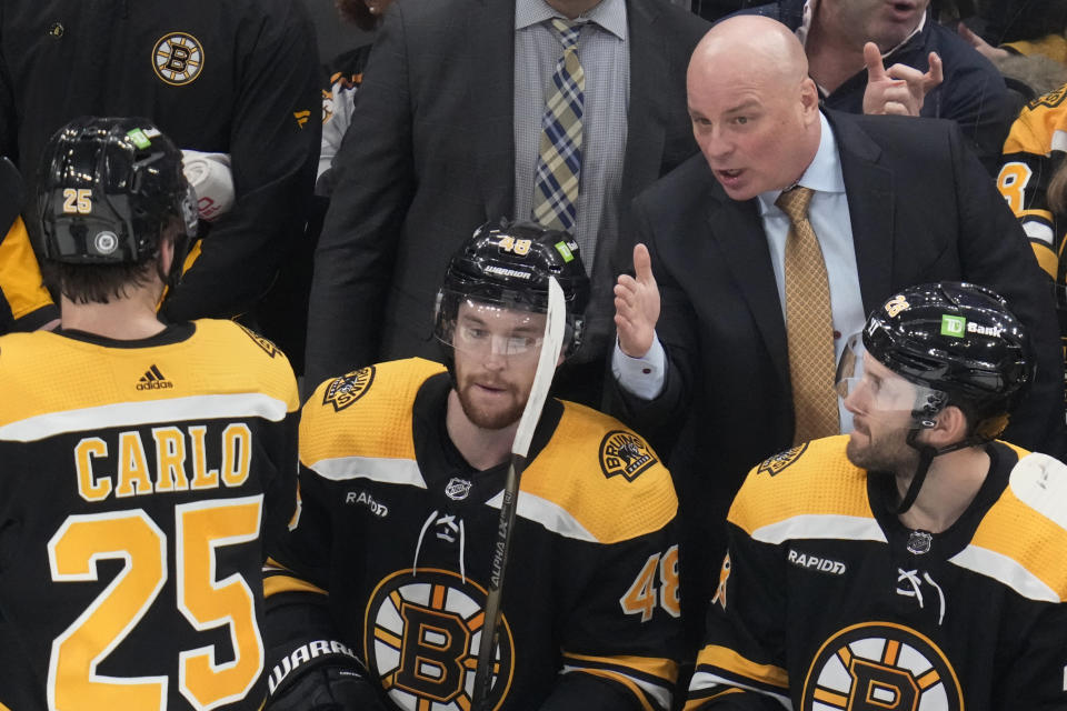 Boston Bruins head coach Jim Montgomery talks with his players during the first period of an NHL hockey game, Monday, Dec. 5, 2022, in Boston. (AP Photo/Charles Krupa, File)