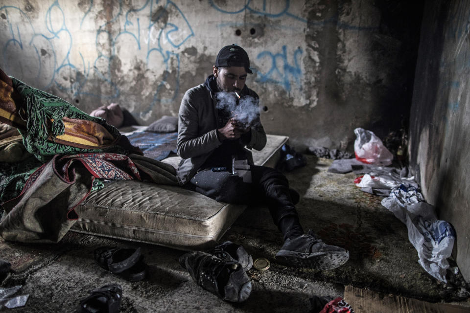 Syrian refugee from Idlib province Mohhamed, 19, lights up a cigarette after breakfast inside an abandoned factory used by migrants as shelter, before making another attempt to cross into Croatia in the outskirts of Bihac, northwestern Bosnia on Dec. 14, 2019. (Photo: Manu Brabo/AP)