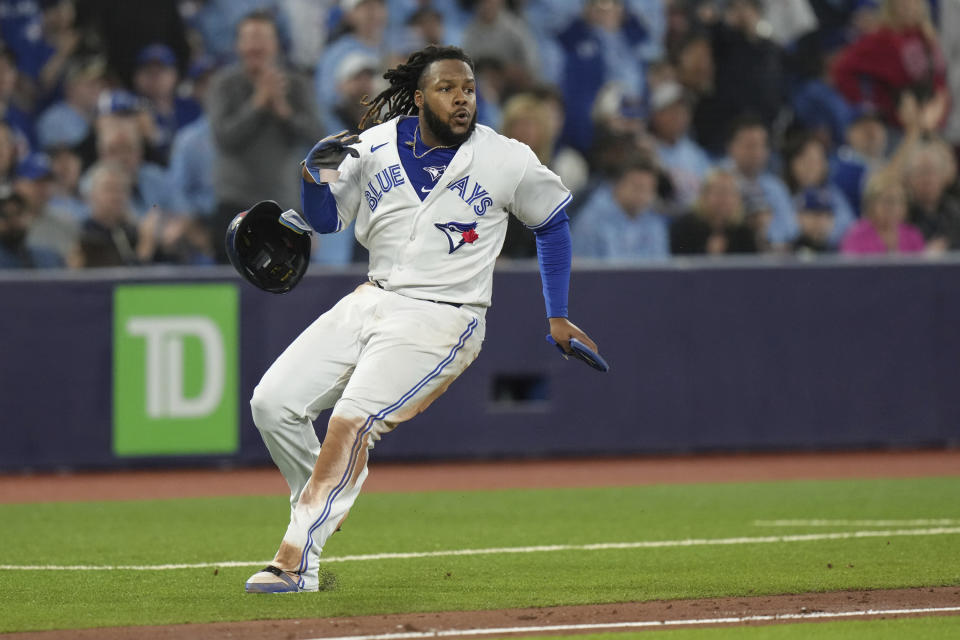 Toronto Blue Jays' Vladimir Guerrero Jr. checks his run to return to third base after a double by teammate Bo Bichette during the sixth inning of a baseball game against the Tampa Bay Rays, Friday, Sept. 29, 2023, in Toronto. (Chris Young/The Canadian Press via AP)