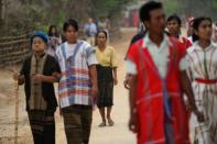 Residents walk to a polling station in Kawhmu, the constituency where Myanmar opposition leader Aung San Suu Kyi is standing on April 1, 2012