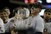 FILE - In this Nov. 1, 2017, file photo, Houston Astros manager A.J. Hinch holds the championship trophy after Game 7 of baseball's World Series against the Los Angeles Dodgers, in Los Angeles. Houston manager AJ Hinch and general manager Jeff Luhnow were suspended for the entire season Monday, Jan. 13, 2020, and the team was fined $5 million for sign-stealing by the team in 2017 and 2018 season. Commissioner Rob Manfred announced the discipline and strongly hinted that current Boston manager Alex Cora — the Astros bench coach in 2017 — will face punishment later. Manfred said Cora developed the sign-stealing system used by the Astros. (AP Photo/Matt Slocum, File)