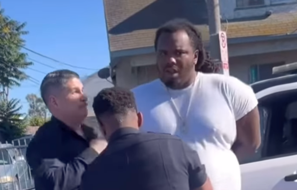 Bystander footage captured an unidentified LAPD officer punching handcuffed motorist Alexander Donta Mitchell, 30, in the face. (Instagram)