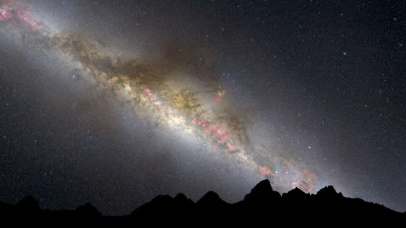 The current night sky is dominated by the white glow of myriad middle-aged stars along the lane of the Milky Way. Interstellar "pollution" from thick dust lanes can be seen threading through the long band of stars. They are interspersed with a