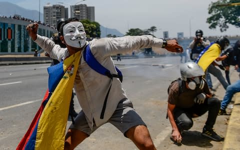 National Guards fired tear gas at a hardcore of demonstrators after the majority of protesters went home - Credit: MATIAS DELACROIX/AFP