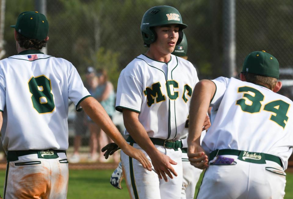 John Shuey of Melbourne Central Catholic hits fives teammates after scoring in the game against the Bloomington Purple Raiders (Bloomington, IL) Wednesday, March 23, 2022. Craig Bailey/FLORIDA TODAY via USA TODAY NETWORK