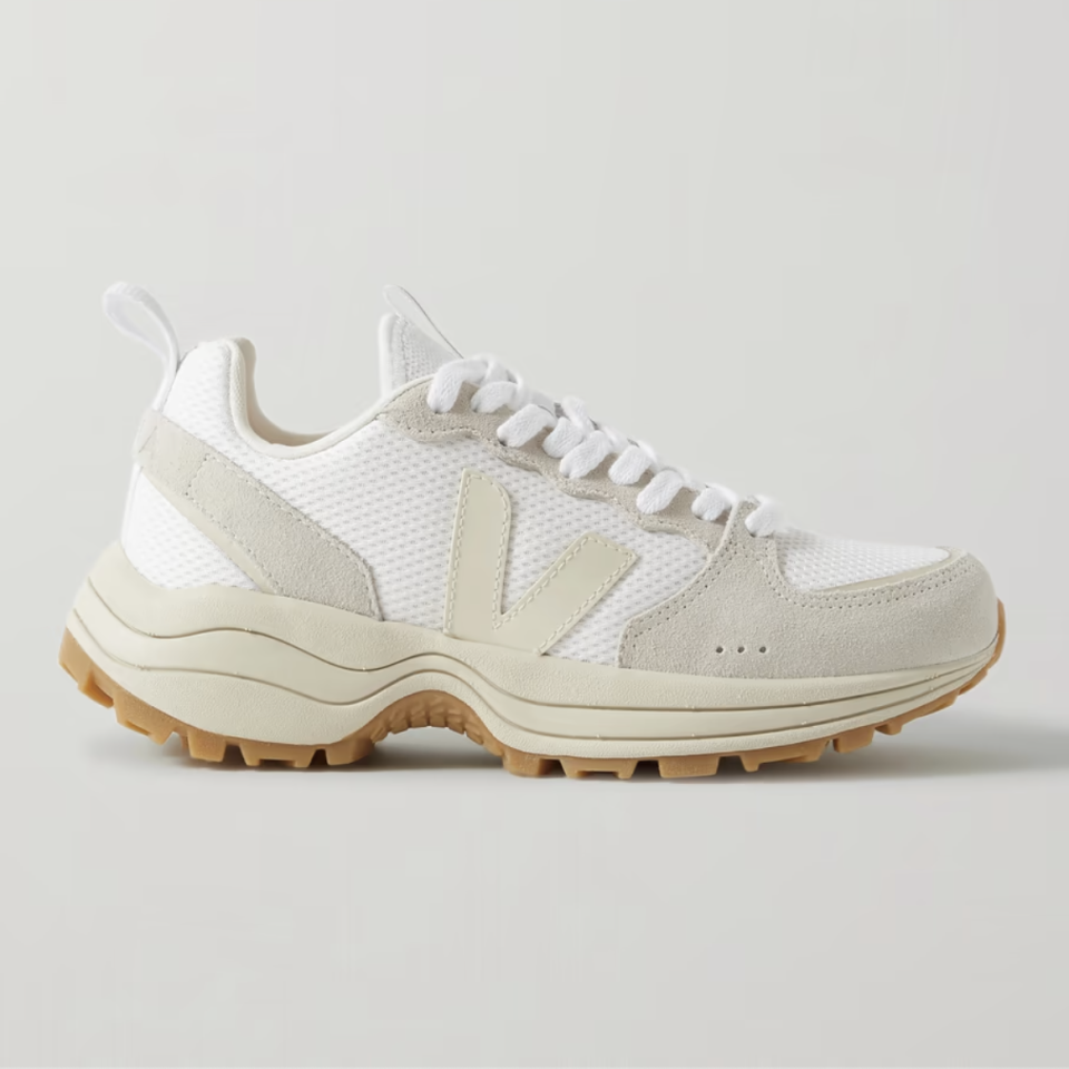 A white mesh sneaker with a chunky sole and beige suede detailing