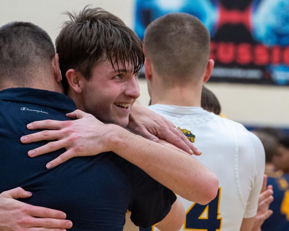 Eastern York’s Austin Bausman hugs coach Justin Seitz after scoring his 1,000th career point in a game against Elco on Thursday, Dec. 29, 2022. He finished with 22 points.