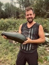 Dan Fenescey shows off some of the zucchini he grew at The Farmology Stand in Harpursville. He and his wife, Jessica; grow vegetables and give them away to anyone who wants them.