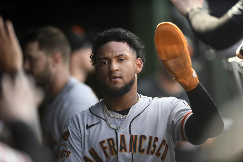 San Francisco Giants' Luis Matos celebrates with teammates in the dugout after scoring on a double hit by Casey Schmitt during the seventh inning of a baseball game against the Chicago Cubs Wednesday, Sept. 6, 2023, in Chicago. (AP Photo/Paul Beaty)