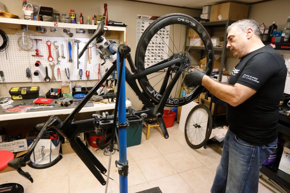 Tony Branco, owner of Scorpion Bike Wheels, installs a set of carbon wheels he built for a customer on the frame of a new bicycle he is building. Mr. Branco started building high performance bicycle wheels in his basement and has now opened his own shop in the Jack Conway Plaza on Route 6 in Dartmouth.
