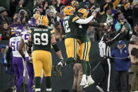 Green Bay Packers quarterback Aaron Rodgers (12) celebrates with teammate Elgton Jenkins after throwing a touchdown pass during the first half of an NFL football game against the Minnesota Vikings, Sunday, Jan. 1, 2023, in Green Bay, Wis. (AP Photo/Morry Gash)