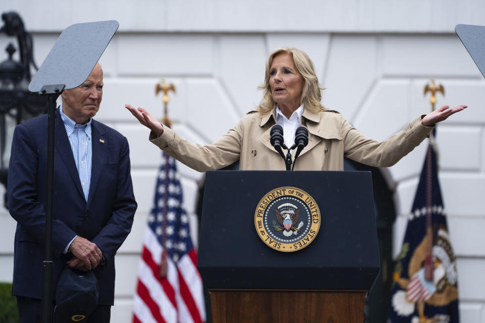 President Joe Biden listens as first lady Jill Biden speaks during a barbecue with active-duty military service members and their families on the South Lawn of the White House, Thursday, July 4, 2024, in Washington. (AP Photo/Evan Vucci)