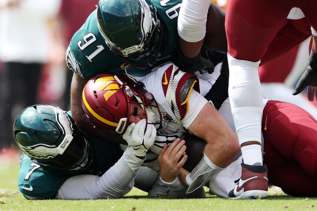 Eagles CARSON WENTZ is tackled by Washington Redskins linebacker