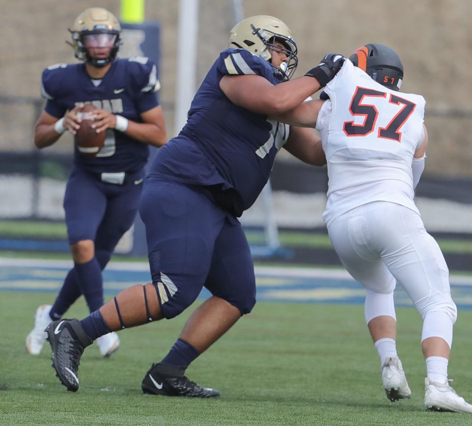 Hoban offensive lineman Keon Johnson puts a block on Cathedral Prep's Benjamin Brzezinski on Friday, Aug. 26, 2022, at Dowed Field.