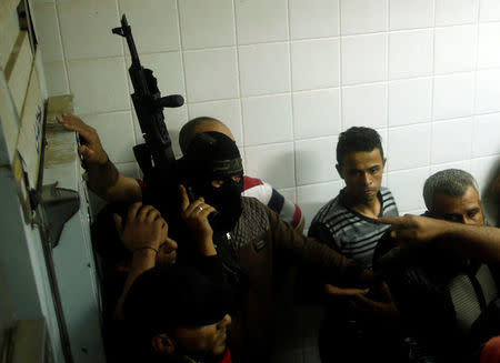 A Palestinian militant stands guard at a hospital in central Gaza Strip October 30, 2017. REUTERS/Mohammed Salem