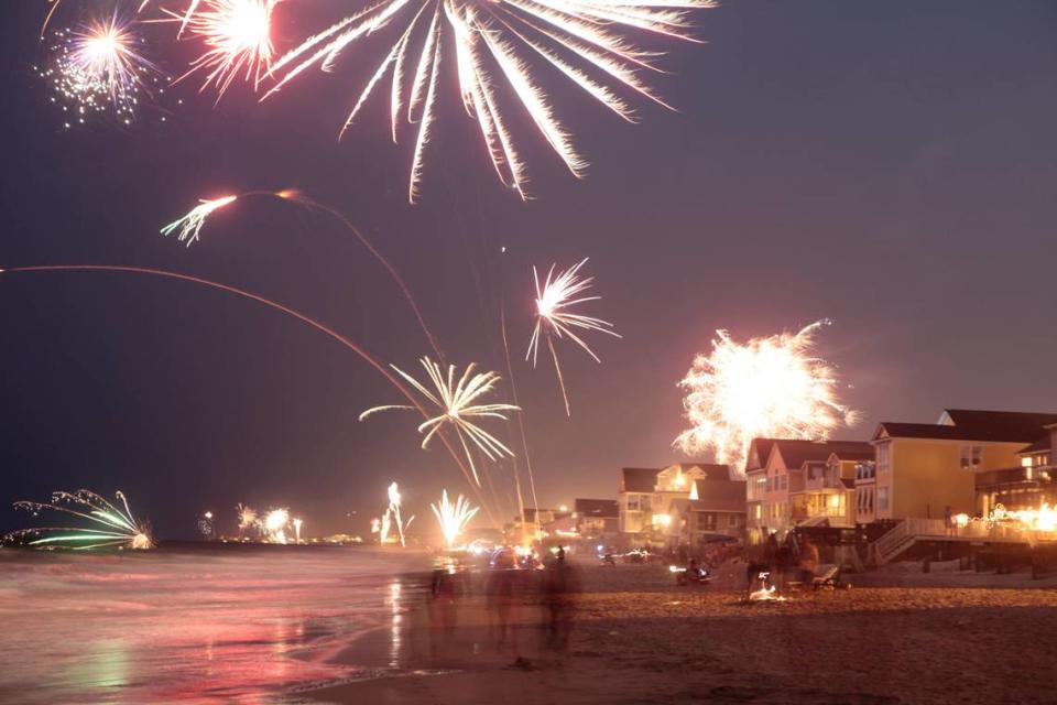 Amateurs ignite fireworks along the shore in Garden City Monday night. Onlookers gathered to watch as amateur and professional displays were set off up and down the coast. Photo by Matt Silfer for The Sun News.