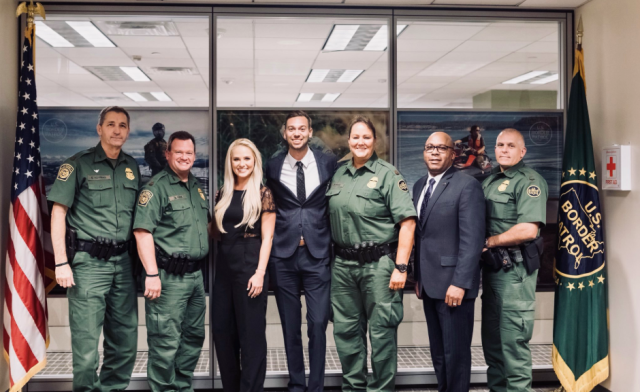 Scott Luck, second from left, posing with far-right commentator Tomi Lahren