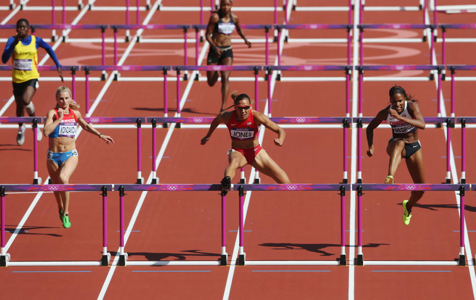 Yuliya Kondakova of Russia, Lolo Jones of the United States and Phylicia George of Canada compete in the Women's 100m Hurdles heat on Day 10 of the London 2012 Olympic Games at the Olympic Stadium on August 6, 2012 in London, England. (Photo by Streeter Lecka/Getty Images)