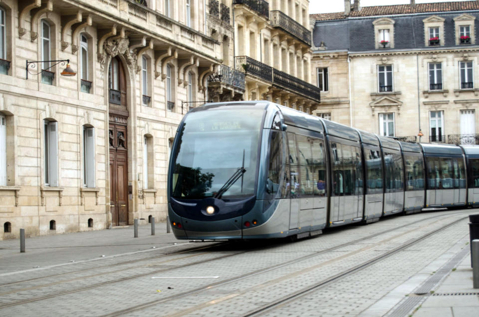 A bus going through an old city