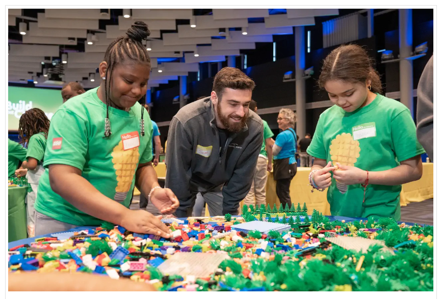 Individuals participate in a Build the Change LEGO workshop.