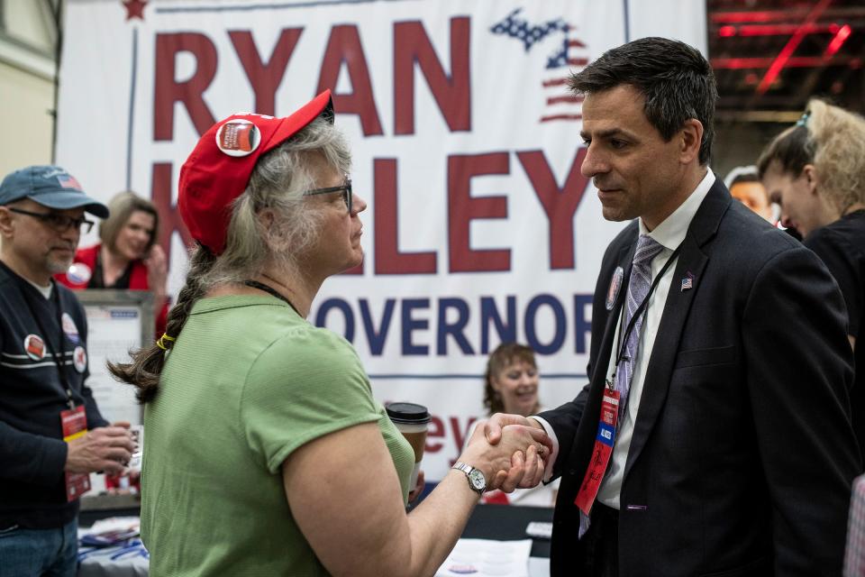 Republican gubernatorial candidate Ryan Kelley talks to delegates and alternates during the MIGOP State Convention at the DeVos Place in Grand Rapids on April 23, 2022.