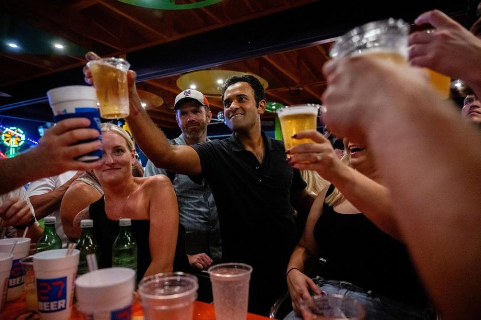 Ramaswamy participates in a toast with supporters at the Jalapeno Pete's bar at the Iowa State Fair in Des Moines on Aug. 11, 2023.<span class="copyright">Brandon Bell—Getty Images</span>